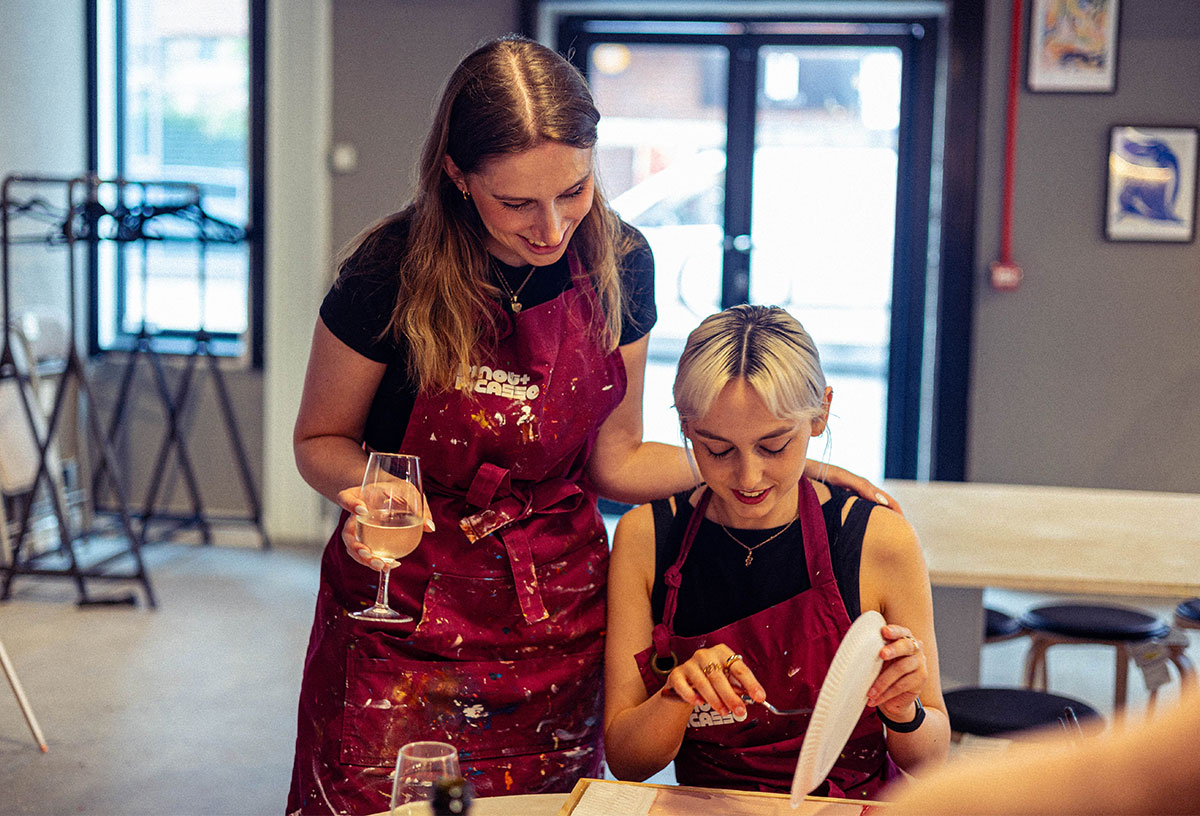 Two girls painting and sipping at Pinot and Picasso Liverpool