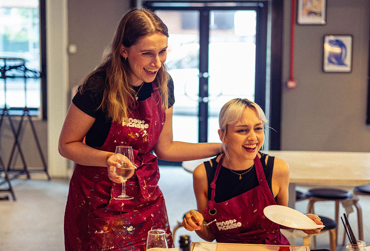 Two girls enjoying a paint and sip class at Pinot and Picasso Leeds